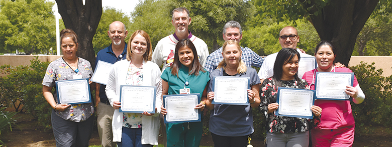 Hospital staffs holding recognition awards